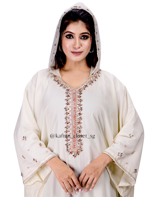 Close up of Model wearing cream white hoodie style embelished kaftan