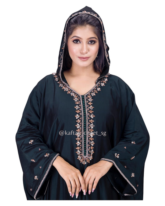 Model wearing midinight green hoodie style embelished kaftan