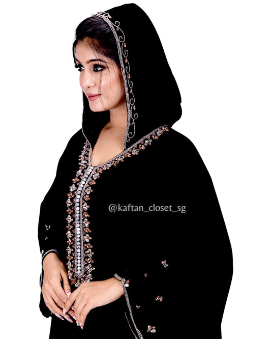 Close up of Model wearing black hoodie style embelished kaftan