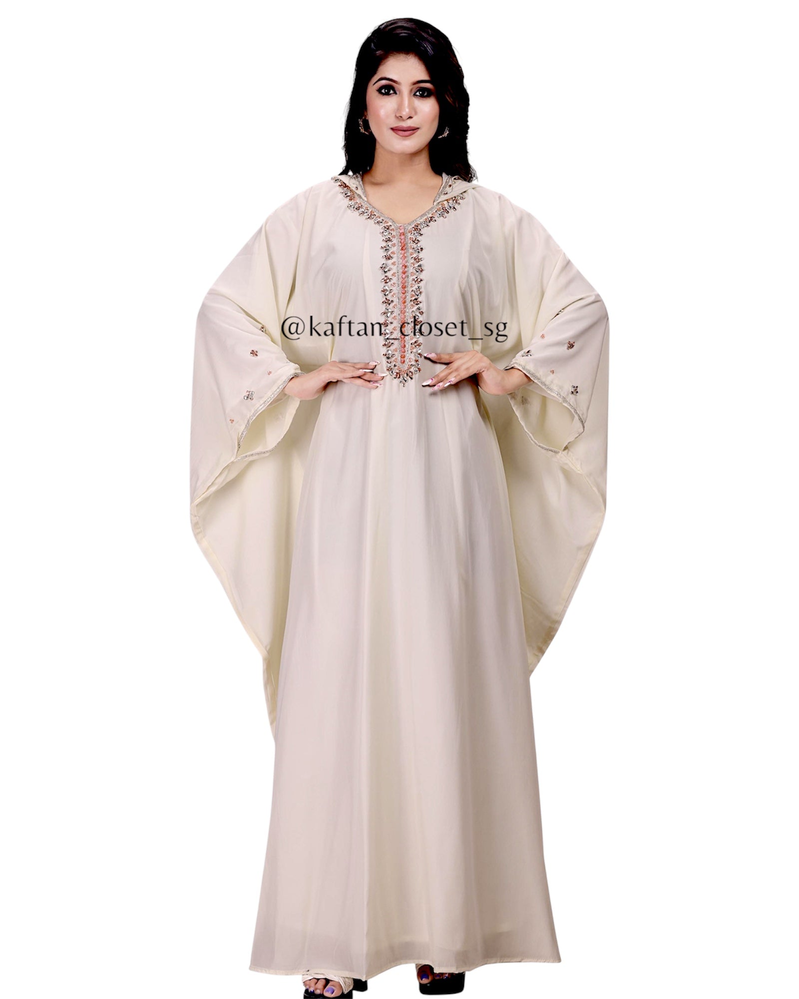 Model wearing cream white hoodie style embelished kaftan