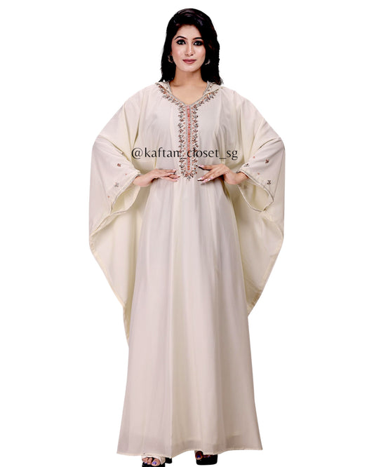 Model wearing cream white hoodie style embelished kaftan