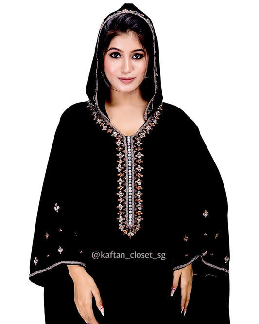 Model wearing black hoodie style embelished kaftan